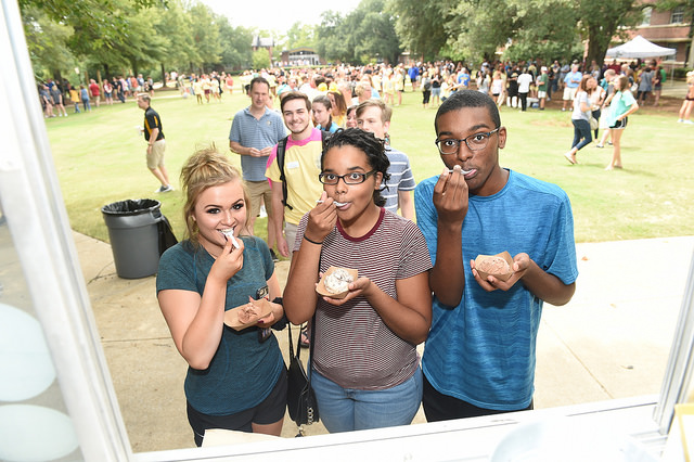 Three first-year students eating ice cream on Residential Quad